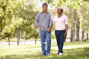 senior couple walking in park