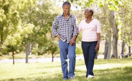 senior couple walking in park