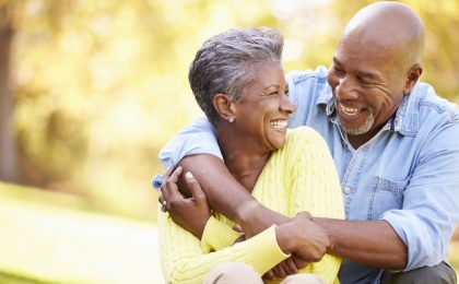 Senior Couple Relaxing In Autumn Landscape