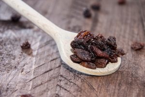 Raisins on a wooden spoon