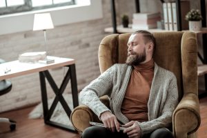 Tired psychologist having a little nap after hard-working day