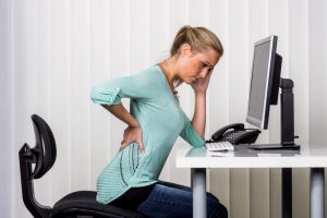 woman with back pain in the office