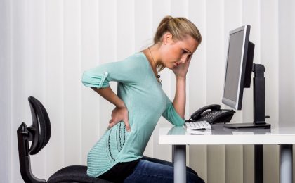 woman with back pain in the office